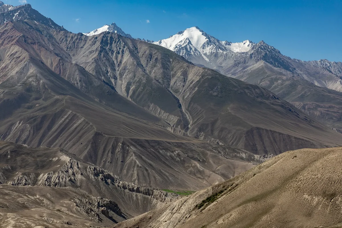 Tacikistan’da Pamir Dağları’nın karlı zirveleri ve çıplak yamaçları